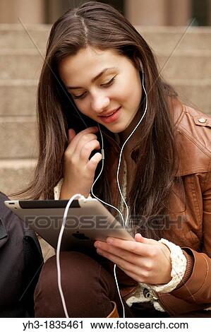 Female student using Skype chat on her iPad View Large Photo Image Stock Image - Female student using Skype chat on her iPad. Fotosearch