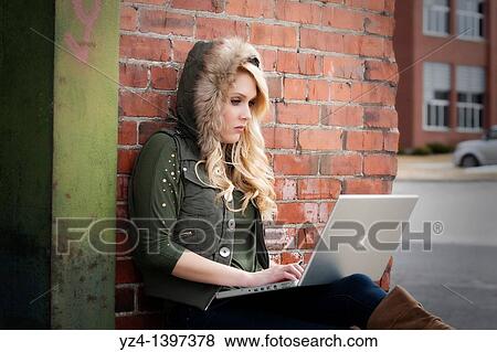 Stock Photo - Female student with a laptop studying. Fotosearch