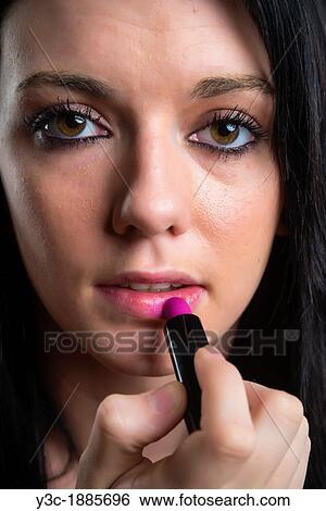 Female teenager, dark hair, applying lipstick, 18 years, Caucasian View Large Photo Image Stock Photograph - Female teenager, dark hair, applying lipstick, 18 years, Caucasian. Fotosearch