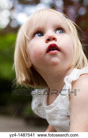 Stock Image - Female toddler enjoying a day at the park. Fotosearch