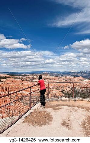 Female tourist enjoys view from Inspiration point, Bryce Canyon national park, Utah, USA View Large Photo Image Stock Photograph - Female tourist enjoys view from Inspiration point, Bryce Canyon national park, Utah, USA. Fotosearch