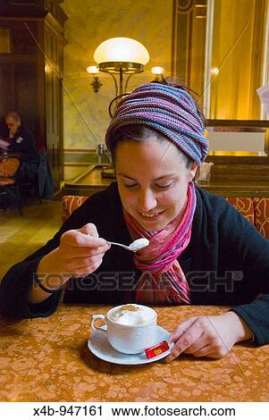 Female tourist tasting the cream in a cappuccino in Cafe Central in Vienna Austria Europe View Large Photo Image Stock Image - Female tourist tasting the cream in a cappuccino in Cafe Central in Vienna Austria Europe. Fotosearch