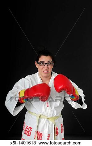 Stock Photo - female Wimp tries to box On black Background. Fotosearch