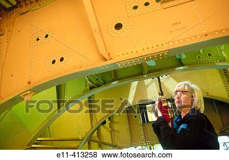 Female worker assembles airplane parts View Large Photo Image Stock Photo - Female worker assembles airplane parts. Fotosearch