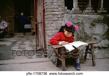 Feng Du, People's Republic of China A young girl does her homework outdoors Yangtze River Area Feng Du is known as the city of Ghosts View Large Photo Image Stock Photograph - Feng Du, People's Republic of China A young girl does her homework outdoors Yangtze River Area Feng Du is known as the city of Ghosts. Fotosearch