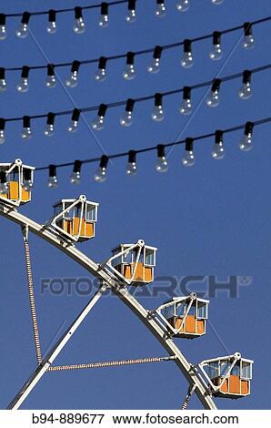 Stock Photo - Ferris wheel and light bulbs, April Fair, Barcelona. Catalonia, Spain. Fotosearch