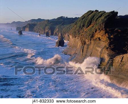 Fertile coastal farmland ends abruptly in sandstone cliffs and stacks at Tongaporutu North Taranaki New Zealand View Large Photo Image Stock Image - Fertile coastal farmland ends abruptly in sandstone cliffs and stacks at Tongaporutu North Taranaki New Zealand. Fotosearch