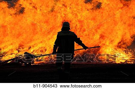 Feuerwehrmann steht vor Flammenwand / Fireman in front of fire View Large Photo Image Stock Image - Feuerwehrmann steht vor Flammenwand / Fireman in front of fire. Fotosearch