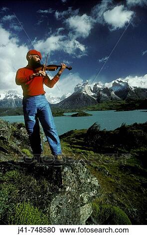 Fiddle player beside Lago Pehoe with view to Cuernos del Paine Torres del Paine National Park Patagonia Chile View Large Photo Image Stock Image - Fiddle player beside Lago Pehoe with view to Cuernos del Paine Torres del Paine National Park Patagonia Chile. Fotosearch