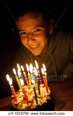 Stock Photography - Fifteen year old Welsh teenage girl blowing out the candles on her birthday cake. Fotosearch