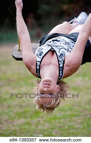 Fifty year old blond woman in fitness attire playing on a rope swing outdoors View Large Photo Image Stock Photo - Fifty year old blond woman in fitness attire playing on a rope swing outdoors. Fotosearch