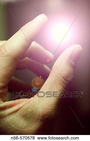 Stock Photo - Fingers holding light. Fotosearch