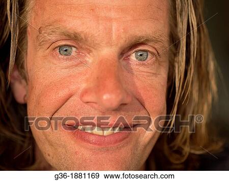 Stock Photo - Finnish man in home in summer light in Nastoland, Finland. Fotosearch