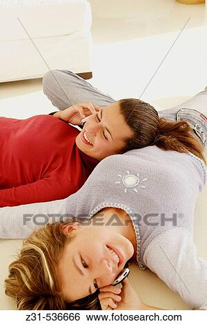 Stock Photograph - Fiona, Carla, Cellular phone, Floor, Telephoning, Together. Fotosearch