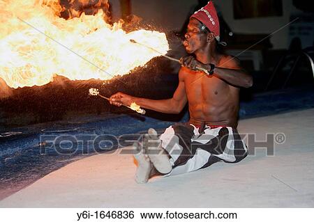 Fire eating dancer performs with drum group Bakau The Gambia View Large Photo Image Stock Photograph - Fire eating dancer performs with drum group Bakau The Gambia. Fotosearch