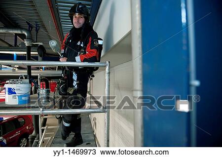 Firefighter in fireproof turnout gear on his regular job in the barracks. View Large Photo Image Stock Image - Firefighter in fireproof turnout gear on his regular job in the barracks.. Fotosearch