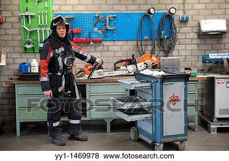 Firefighter in fireproof turnout gear on his regular job in the barracks. View Large Photo Image Stock Photo - Firefighter in fireproof turnout gear on his regular job in the barracks.. Fotosearch