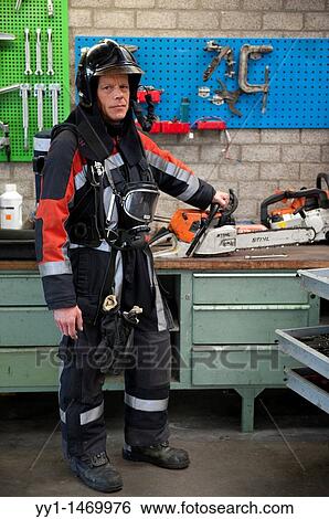 Firefighter in fireproof turnout gear on his regular job in the barracks. View Large Photo Image Stock Photograph - Firefighter in fireproof turnout gear on his regular job in the barracks.. Fotosearch