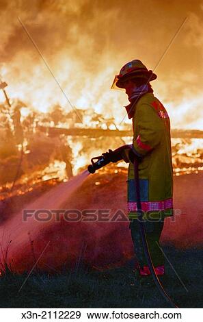 Firefighter spraying fire with hose. View Large Photo Image Stock Photo - Firefighter spraying fire with hose.. Fotosearch