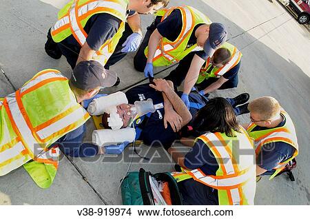 Picture - firefighters and medics work on an injured man in Bladensburg, Maryland, USA. Fotosearch