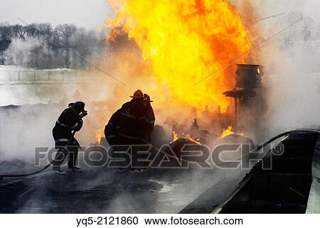 Stock Image - Firefighters battle tanker truck fire on highway.. Fotosearch