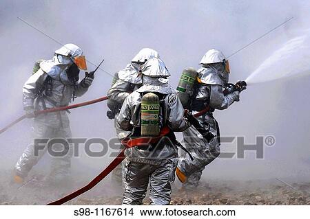 Picture - Firefighters battle the smoke during a live fire response exercise July 21, 2010, at the Combat Readiness Training Center in Alpena, Mich The firefighters are with the Michigan Air National Guard 127th Wing at Selfridge Air National Base. Fotosearch