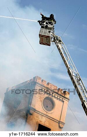 Firemen extinguishing fire at Can Ricart, Barcelona, Spain View Large Photo Image Picture - Firemen extinguishing fire at Can Ricart, Barcelona, Spain. Fotosearch