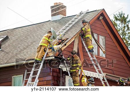 Stock Photo - Firemen working on a house.. Fotosearch