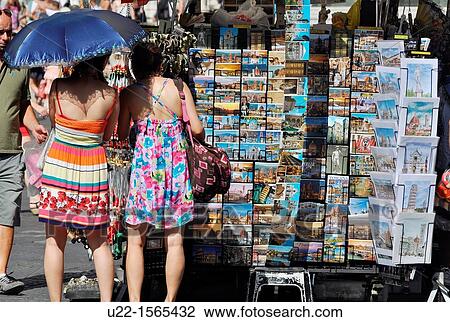 Stock Image - Firenze (Italy): tourists buying postcards in Piazza San Giovanni. Fotosearch