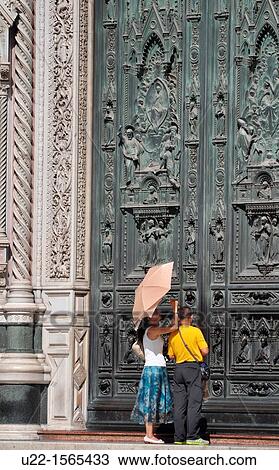 Stock Image - Firenze (Italy): tourists by the main door of Santa Maria del Fiore Cathedral. Fotosearch