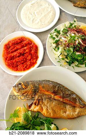 Fish from the Beysehir Gol? lake, with salads of hot tomatoes, yogurt with cucumber and parsley with onions, Central Anatolia, Turkey View Large Photo Image Stock Photo - Fish from the Beysehir Gol? lake, with salads of hot tomatoes, yogurt with cucumber and parsley with onions, Central Anatolia, Turkey. Fotosearch