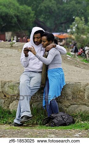 Fish Market at Lake Awassa in Awassa Ethiopia Africa with young local couple hugging while texting on cell phone 31 View Large Photo Image Stock Photography - Fish Market at Lake Awassa in Awassa Ethiopia Africa with young local couple hugging while texting on cell phone 31. Fotosearch