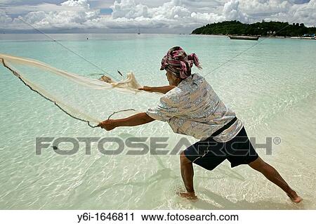 Fisherman casting net by hand Pattaya Beach Ko Lipe island Thailand View Large Photo Image Stock Image - Fisherman casting net by hand Pattaya Beach Ko Lipe island Thailand. Fotosearch