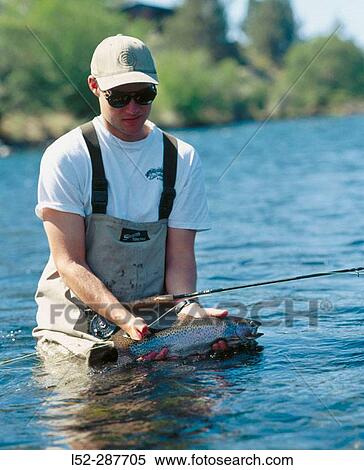 Fisherman holding trout fly-fishing. Deschutes River. Warm Springs. Oregon. USA View Large Photo Image Stock Photography - Fisherman holding trout fly-fishing. Deschutes River. Warm Springs. Oregon. USA. Fotosearch