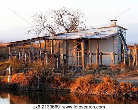 Fisherman hut at Lo Golero draining channel of Fangar Bay. Ebro River Delta Natural Park, Tarragona province, Catalonia, Spain. View Large Photo Image Stock Photo - Fisherman hut at Lo Golero draining channel of Fangar Bay. Ebro River Delta Natural Park, Tarragona province, Catalonia, Spain.. Fotosearch