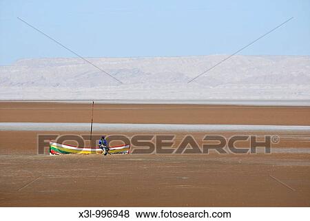 Fisherman in Chott El Jerid salted lake, Tunisia View Large Photo Image Stock Photo - Fisherman in Chott El Jerid salted lake, Tunisia. Fotosearch