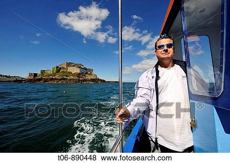 Fisherman in his boat for crab fishing Guernsey, Channel Islands, UK View Large Photo Image Stock Photo - Fisherman in his boat for crab fishing Guernsey, Channel Islands, UK. Fotosearch