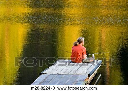 Fisherman in red shirt trying his luck from a dock on Black Pine Lake North Cascades Washington USA View Large Photo Image Stock Image - Fisherman in red shirt trying his luck from a dock on Black Pine Lake North Cascades Washington USA. Fotosearch