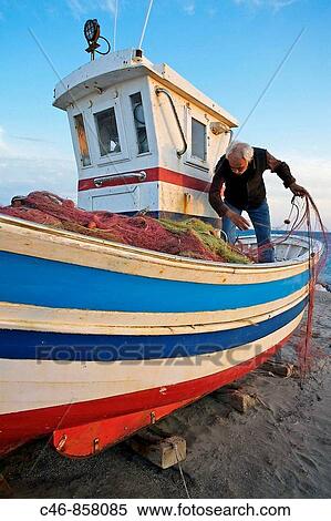 Stock Photography - Fisherman. La Almadrava de Monteleva beach. Cabo de Gata _ Nijar Natural Park. Almeria Province. Andalucia. Spain.. Fotosearch