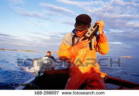 Stock Photo - Fisherman listening to the weather forecast. Havstenssund. Bohusln. West coast of Sweden. Fotosearch