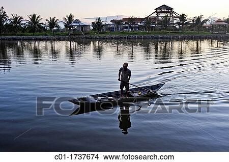Fisherman on boat at sunset, Da Nang, Central Vietnam View Large Photo Image Picture - Fisherman on boat at sunset, Da Nang, Central Vietnam. Fotosearch