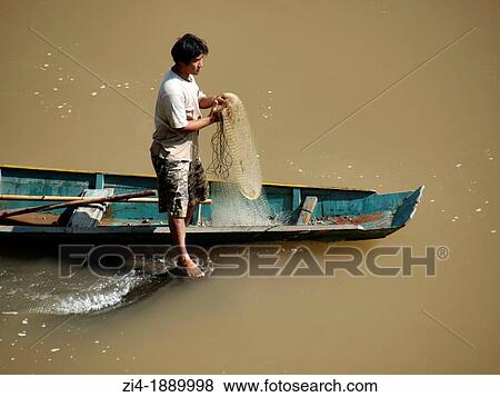 Fisherman on his boat holding a net on the Mekong River in Luang Prabang View Large Photo Image Stock Photo - Fisherman on his boat holding a net on the Mekong River in Luang Prabang. Fotosearch