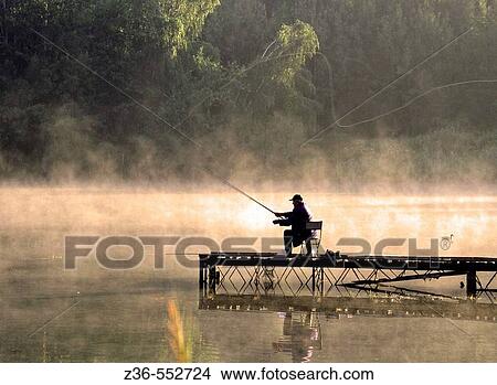 Picture - Fisherman on lake. Fotosearch