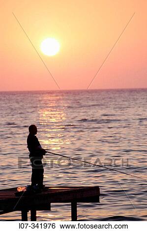 Fisherman on pier at sunset. Kusadasi. Turkey View Large Photo Image Stock Photograph - Fisherman on pier at sunset. Kusadasi. Turkey. Fotosearch