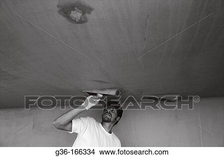 Fisherman painting boat hull View Large Photo Image Picture - Fisherman painting boat hull. Fotosearch