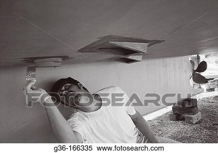 Fisherman painting boat hull View Large Photo Image Stock Photography - Fisherman painting boat hull. Fotosearch