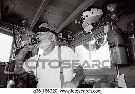 Fisherman piloting boat View Large Photo Image Stock Image - Fisherman piloting boat. Fotosearch