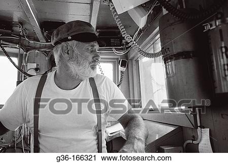 Fisherman piloting boat View Large Photo Image Stock Image - Fisherman piloting boat. Fotosearch