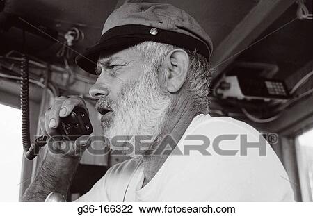 Fisherman piloting boat View Large Photo Image Stock Image - Fisherman piloting boat. Fotosearch