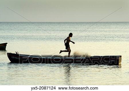Picture - Fisherman preparing fishing net on a small boat near Farallon village, Cocle Province, Panama.. Fotosearch